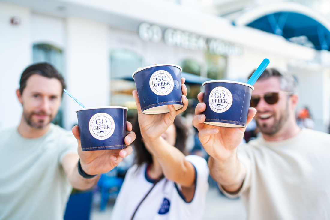 3 people holding greek yogurt