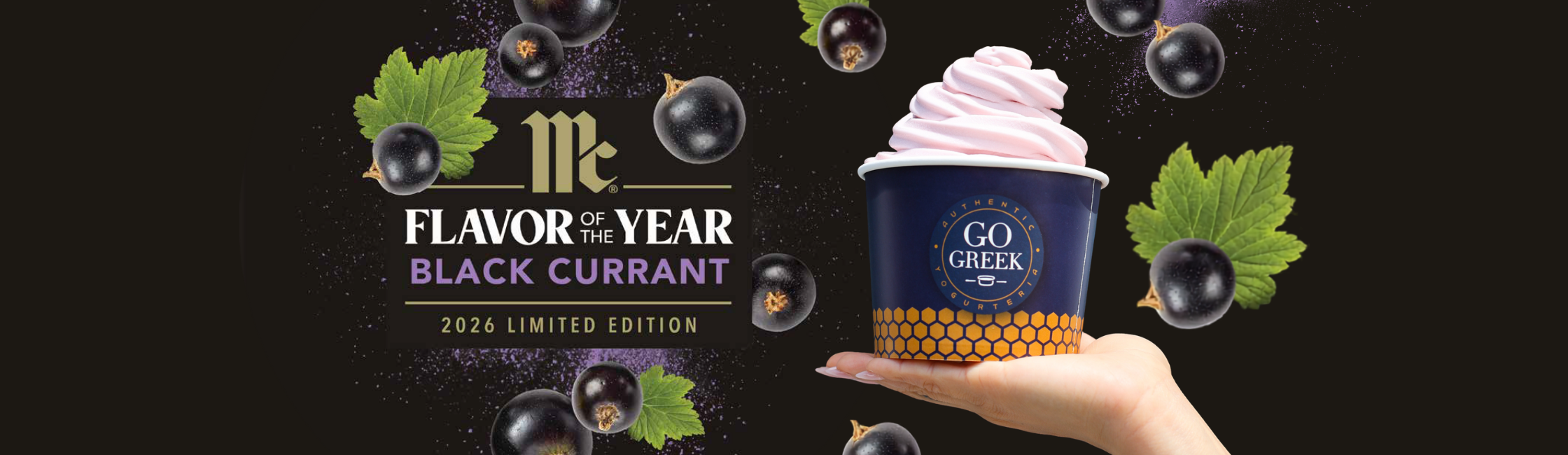 A hand holds a cup of pink soft-serve ice cream topped with a blackcurrant swirl, set against a dark background with floating blackcurrants, leaves, and the text 'Flavor of the Year Black Currant 2026 Limited Edition', the McCormick logo, and the GO GREEK logo.